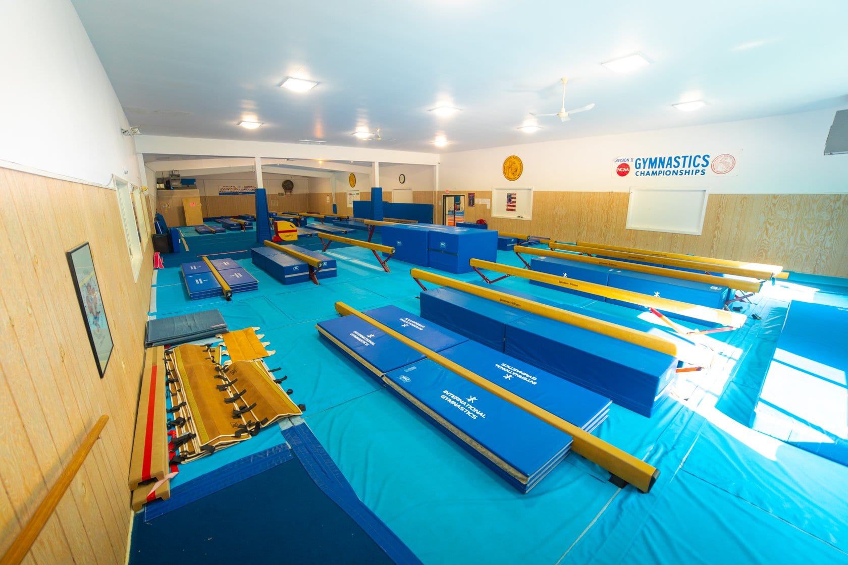 Gymnastics training area with mats and equipment.